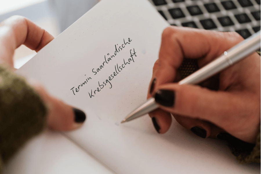 Eine Frau schreibt auf einen Notizblock